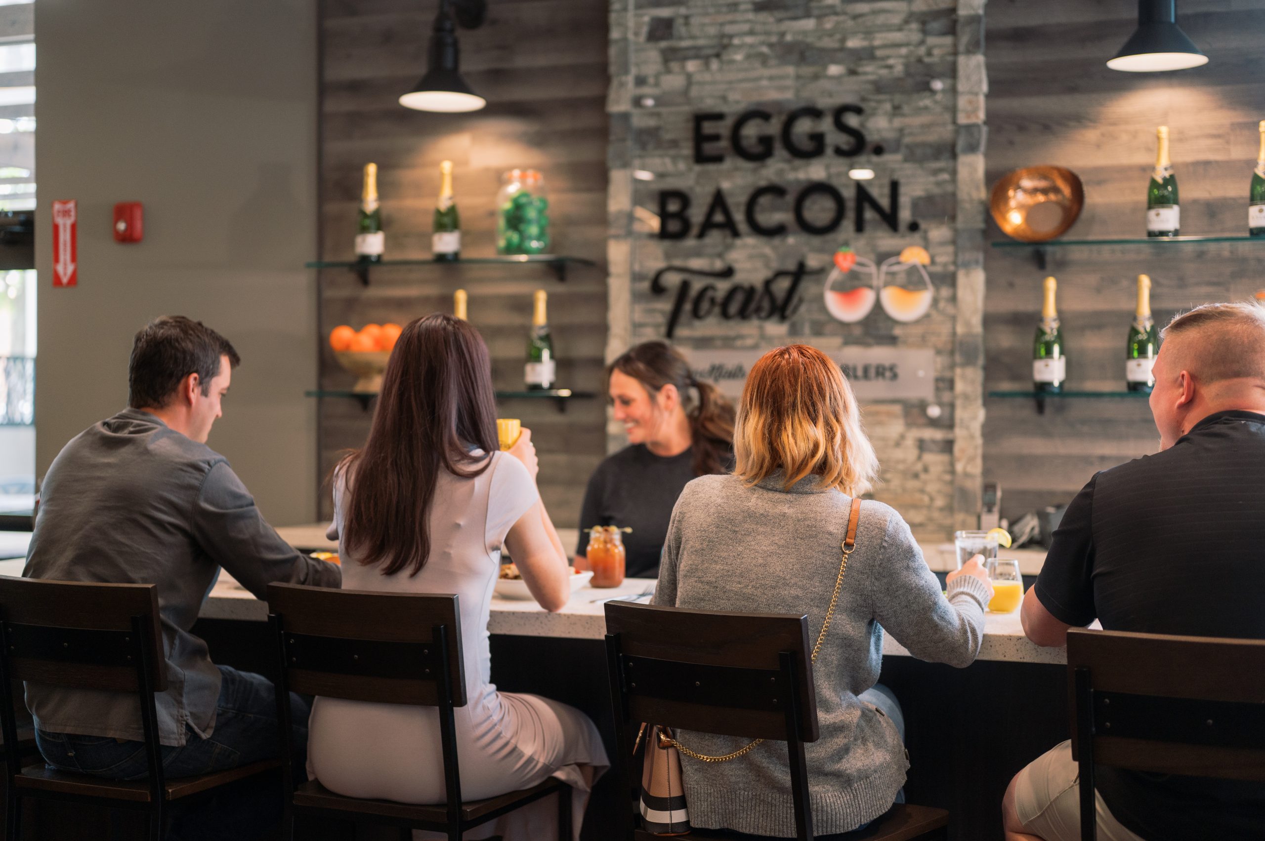 guests happily enjoying brunch at a restaurant with an online waitlist near you.